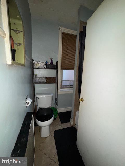 bathroom featuring tile patterned flooring and toilet