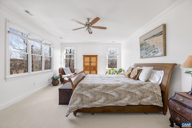 carpeted bedroom with a ceiling fan, baseboards, visible vents, and crown molding