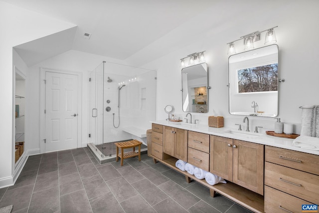 full bath with double vanity, a stall shower, visible vents, and a sink