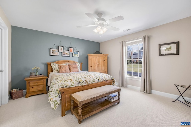 bedroom with baseboards, visible vents, a ceiling fan, and light colored carpet