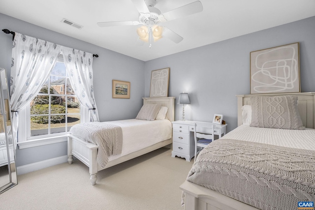 bedroom featuring baseboards, ceiling fan, visible vents, and light colored carpet