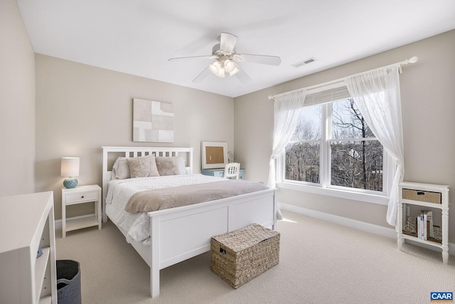 bedroom with carpet floors, visible vents, ceiling fan, and baseboards