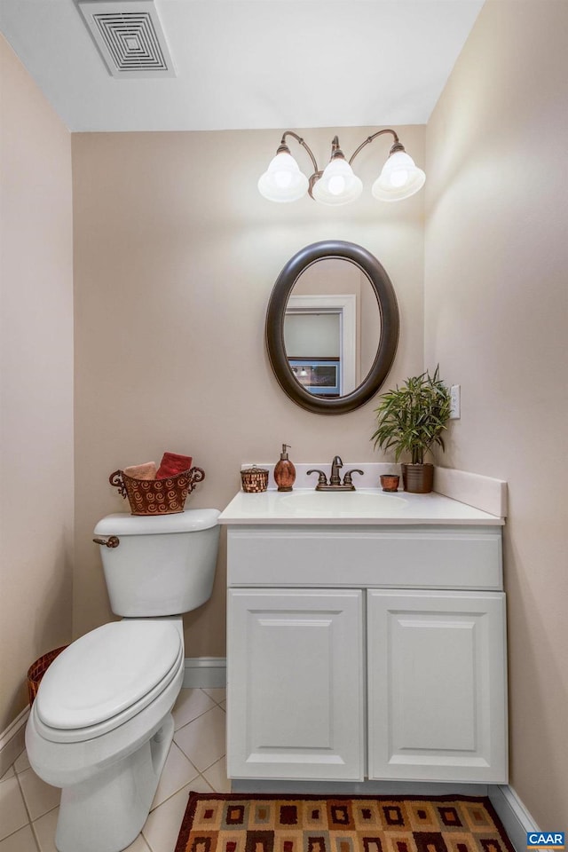 bathroom featuring visible vents, vanity, toilet, and tile patterned floors