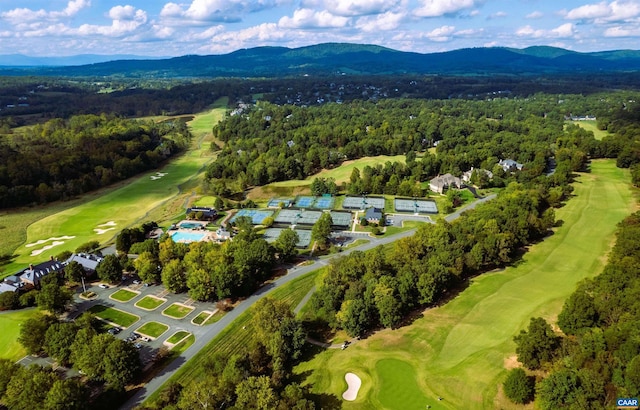 bird's eye view with view of golf course, a mountain view, and a forest view