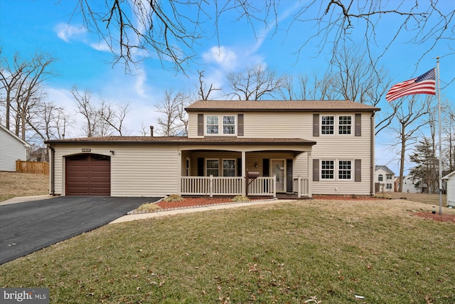 view of front facade with a porch, a garage, driveway, and a front lawn