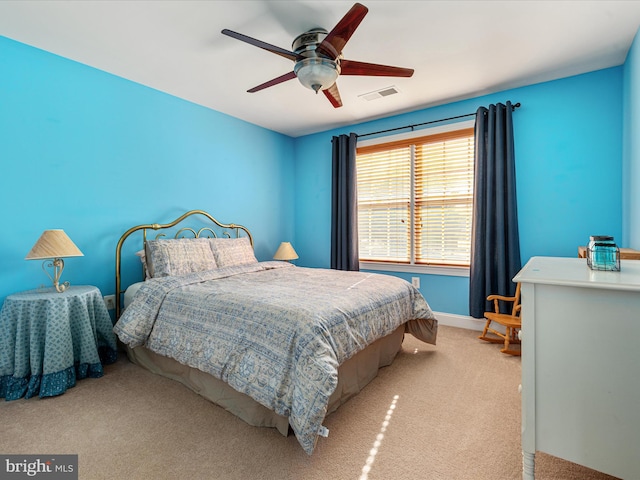 carpeted bedroom featuring visible vents, ceiling fan, and baseboards