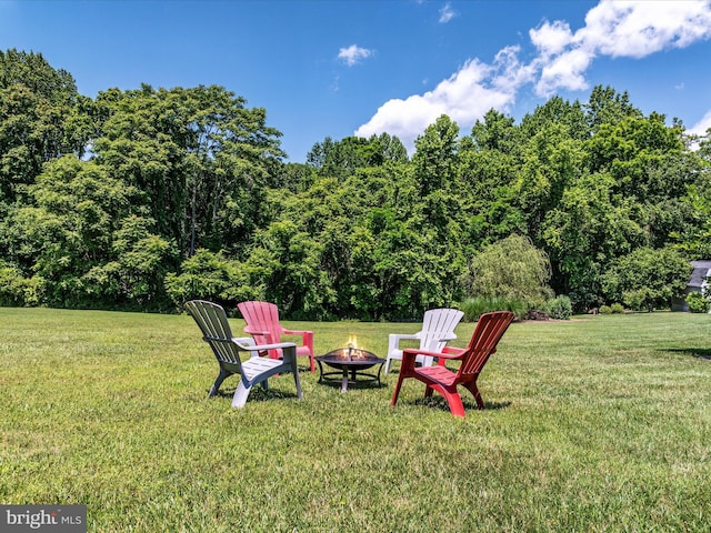 view of yard with an outdoor fire pit