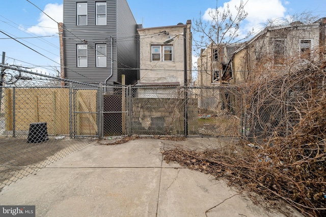 back of house with fence and a gate