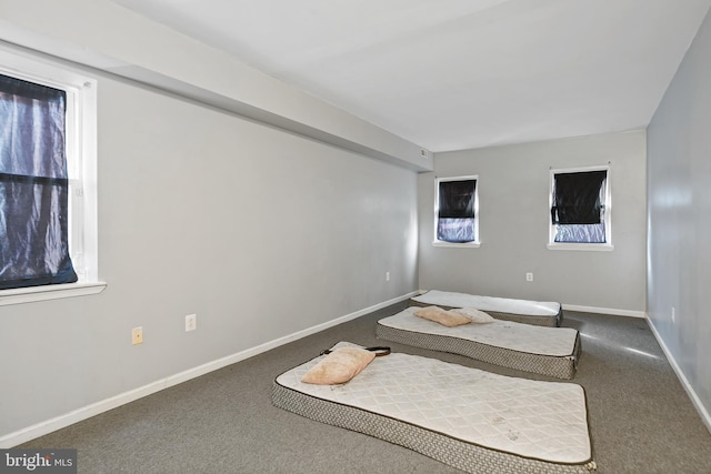 carpeted bedroom with baseboards