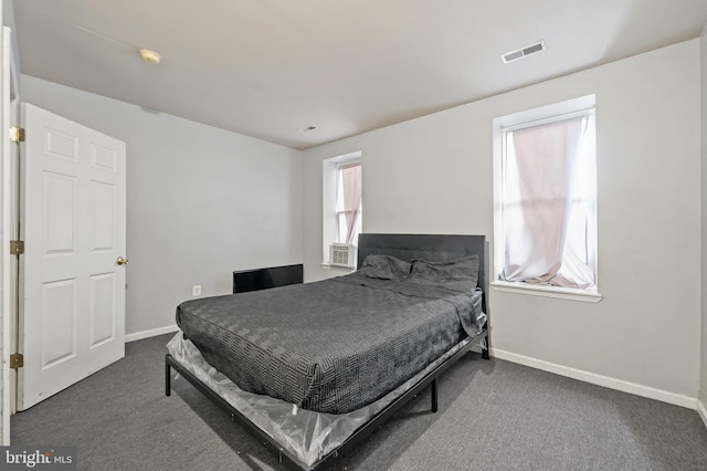 carpeted bedroom featuring baseboards and visible vents