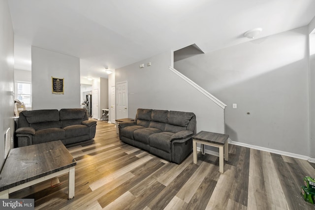 living area featuring baseboards and wood finished floors