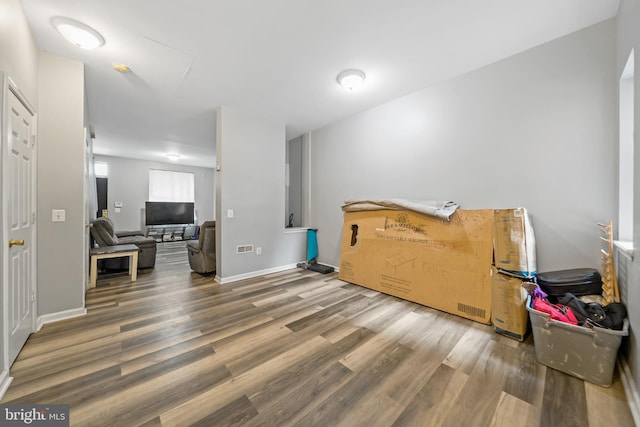 interior space featuring wood finished floors and baseboards