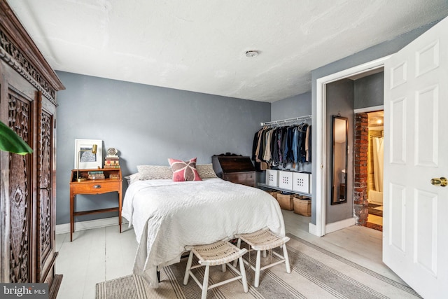 bedroom featuring light wood-style flooring and baseboards