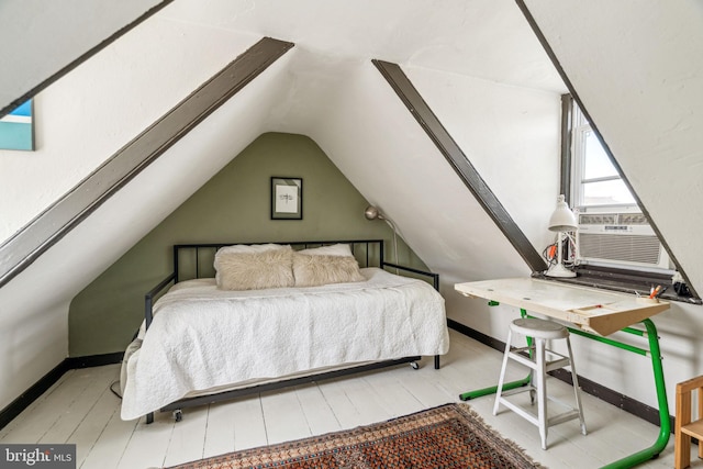 bedroom with baseboards, vaulted ceiling, cooling unit, and wood finished floors