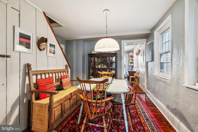 dining area featuring wood finished floors and baseboards