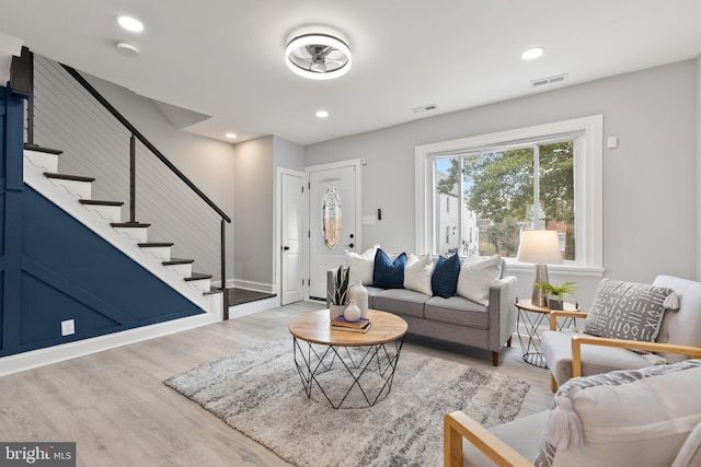 living room with light wood finished floors, stairway, visible vents, and recessed lighting