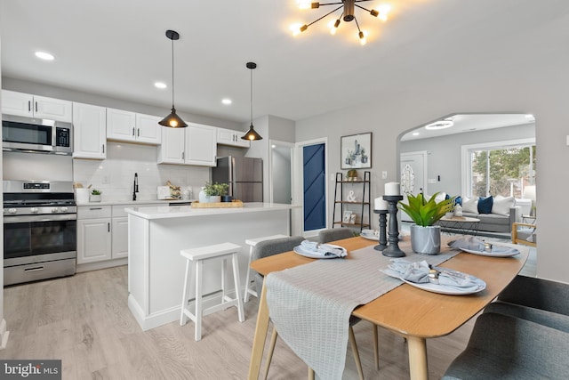 kitchen with white cabinets, appliances with stainless steel finishes, and light countertops