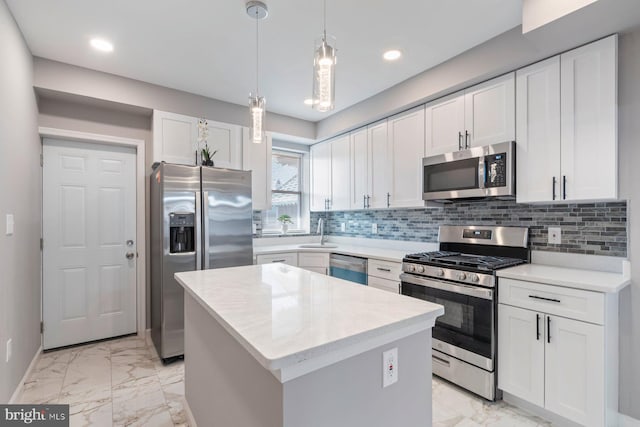 kitchen with marble finish floor, stainless steel appliances, and backsplash