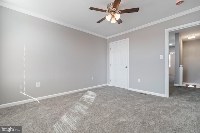 unfurnished bedroom featuring a ceiling fan, carpet flooring, crown molding, and baseboards