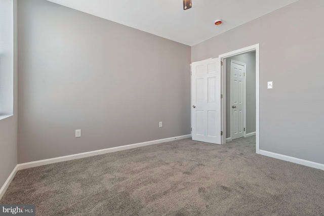 unfurnished bedroom with carpet floors and baseboards