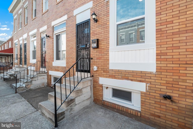 view of exterior entry with brick siding