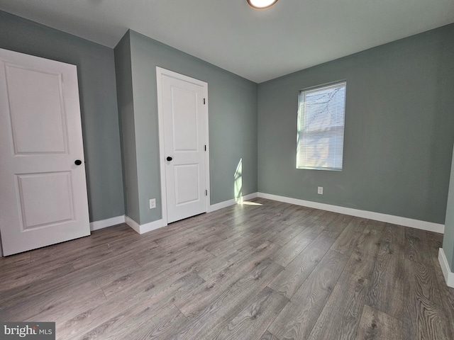 unfurnished bedroom featuring baseboards and light wood-style floors