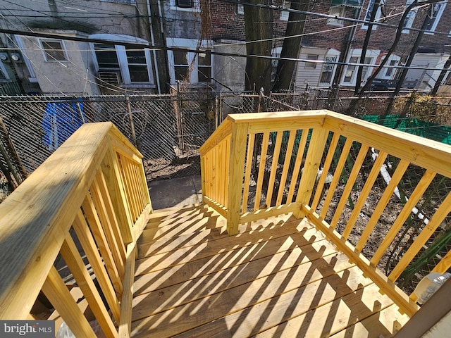 wooden terrace featuring fence