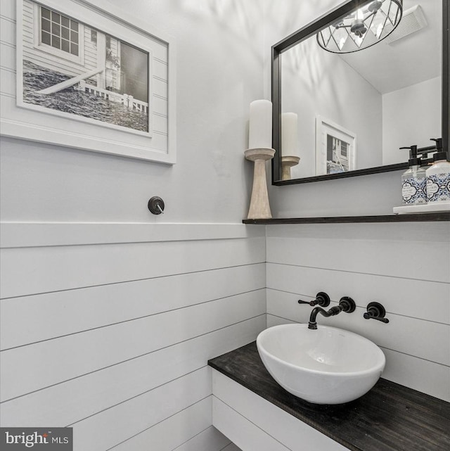 bathroom with visible vents and a sink