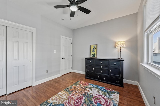 bedroom with wood finished floors, baseboards, and ceiling fan