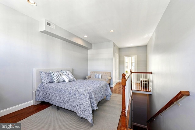 bedroom with visible vents, recessed lighting, baseboards, and wood finished floors