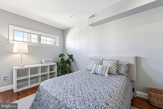 bedroom with recessed lighting, wood finished floors, visible vents, and baseboards