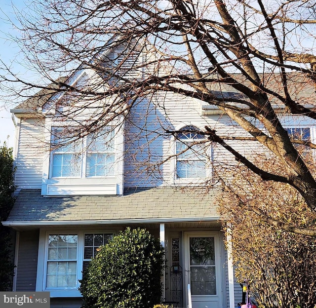 exterior space featuring a shingled roof