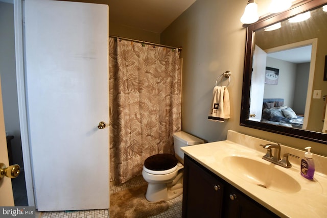 bathroom featuring toilet, tile patterned floors, and vanity