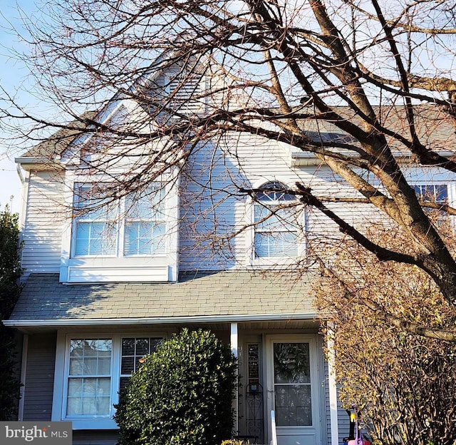 exterior space with roof with shingles