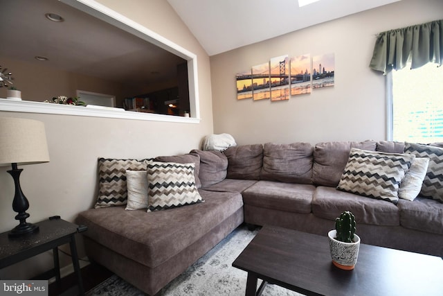 living room featuring lofted ceiling