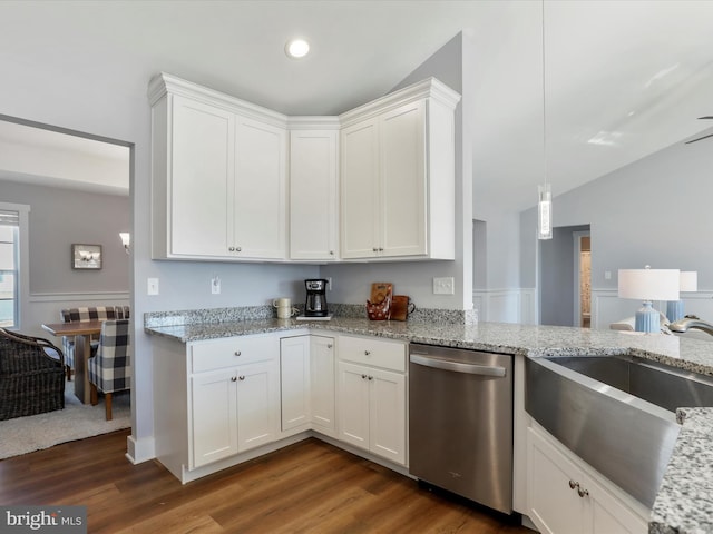 kitchen with dark wood finished floors, light stone counters, stainless steel dishwasher, white cabinetry, and a sink