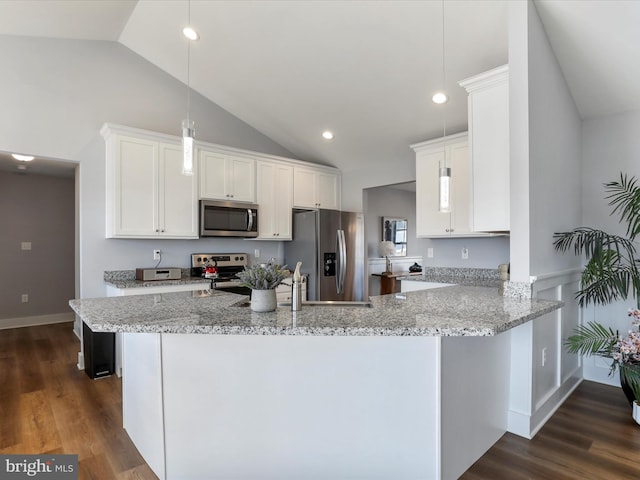 kitchen featuring dark wood-style floors, stainless steel appliances, white cabinetry, and light stone countertops