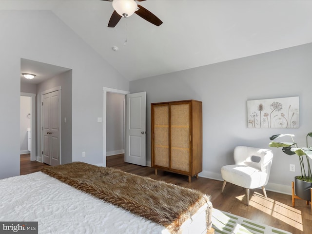 bedroom with high vaulted ceiling, wood finished floors, a ceiling fan, and baseboards