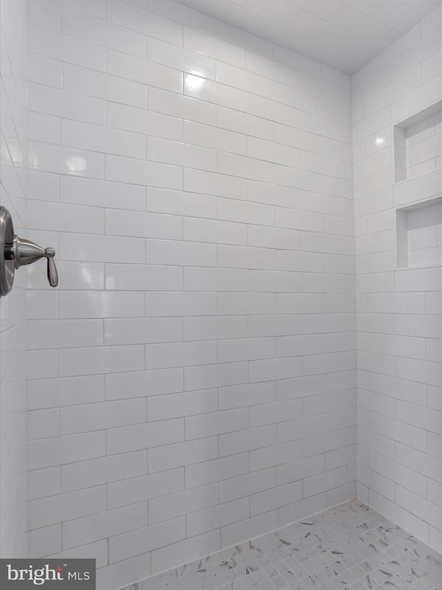 bathroom with tiled shower