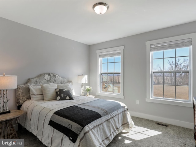 bedroom featuring carpet, visible vents, and baseboards