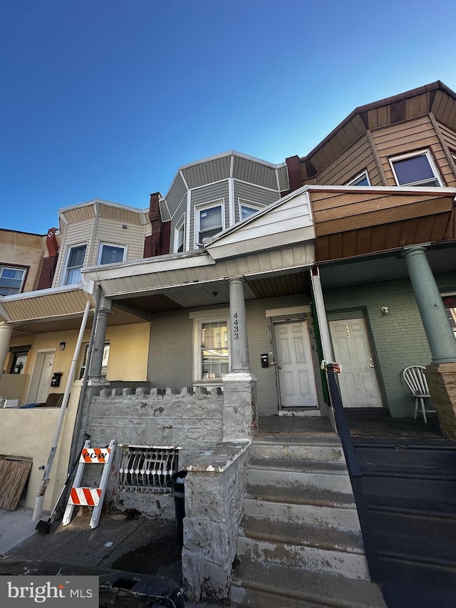 multi unit property with covered porch and brick siding