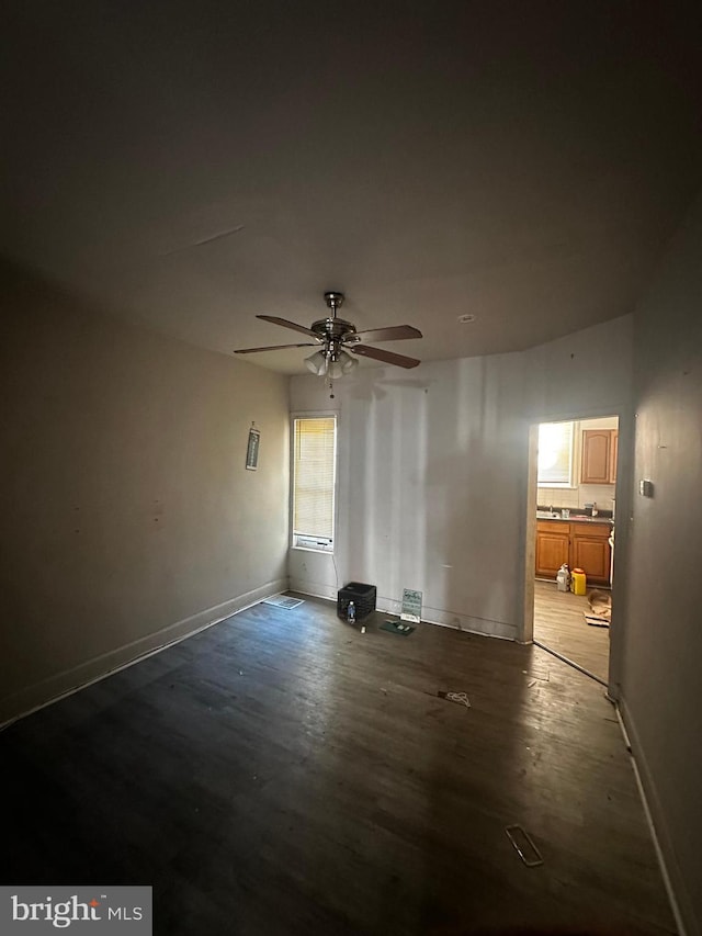 interior space featuring ceiling fan and baseboards