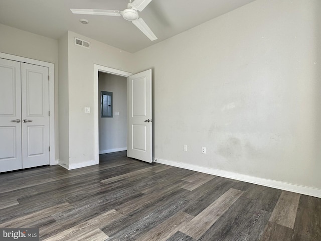 unfurnished bedroom with baseboards, visible vents, ceiling fan, wood finished floors, and a closet