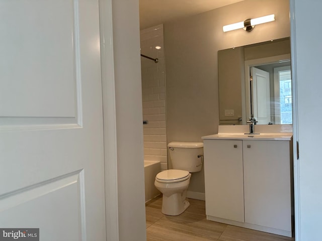 bathroom with toilet, shower / bathtub combination, and vanity