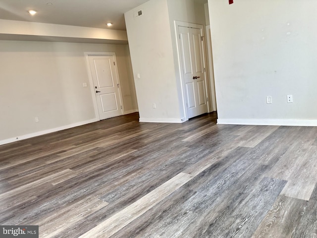 empty room with visible vents, baseboards, and wood finished floors