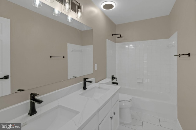 full bath featuring toilet, marble finish floor, shower / washtub combination, and a sink