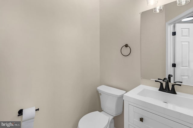 bathroom featuring toilet and vanity