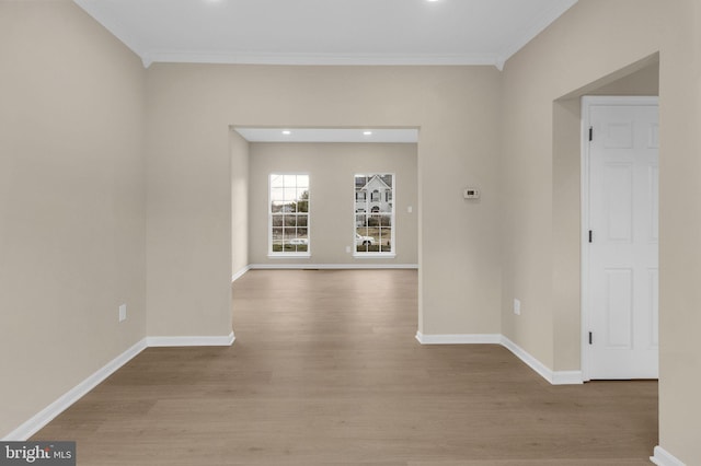 unfurnished room featuring light wood-style floors, recessed lighting, ornamental molding, and baseboards