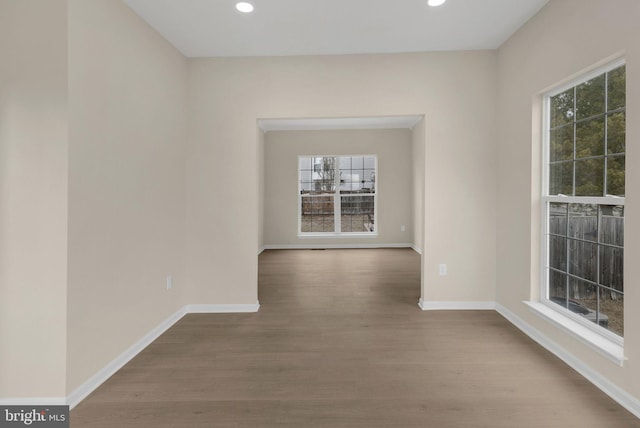 unfurnished room with recessed lighting, light wood-style flooring, and baseboards