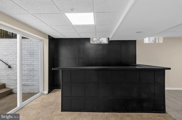 bar featuring stairway, a drop ceiling, visible vents, and baseboards